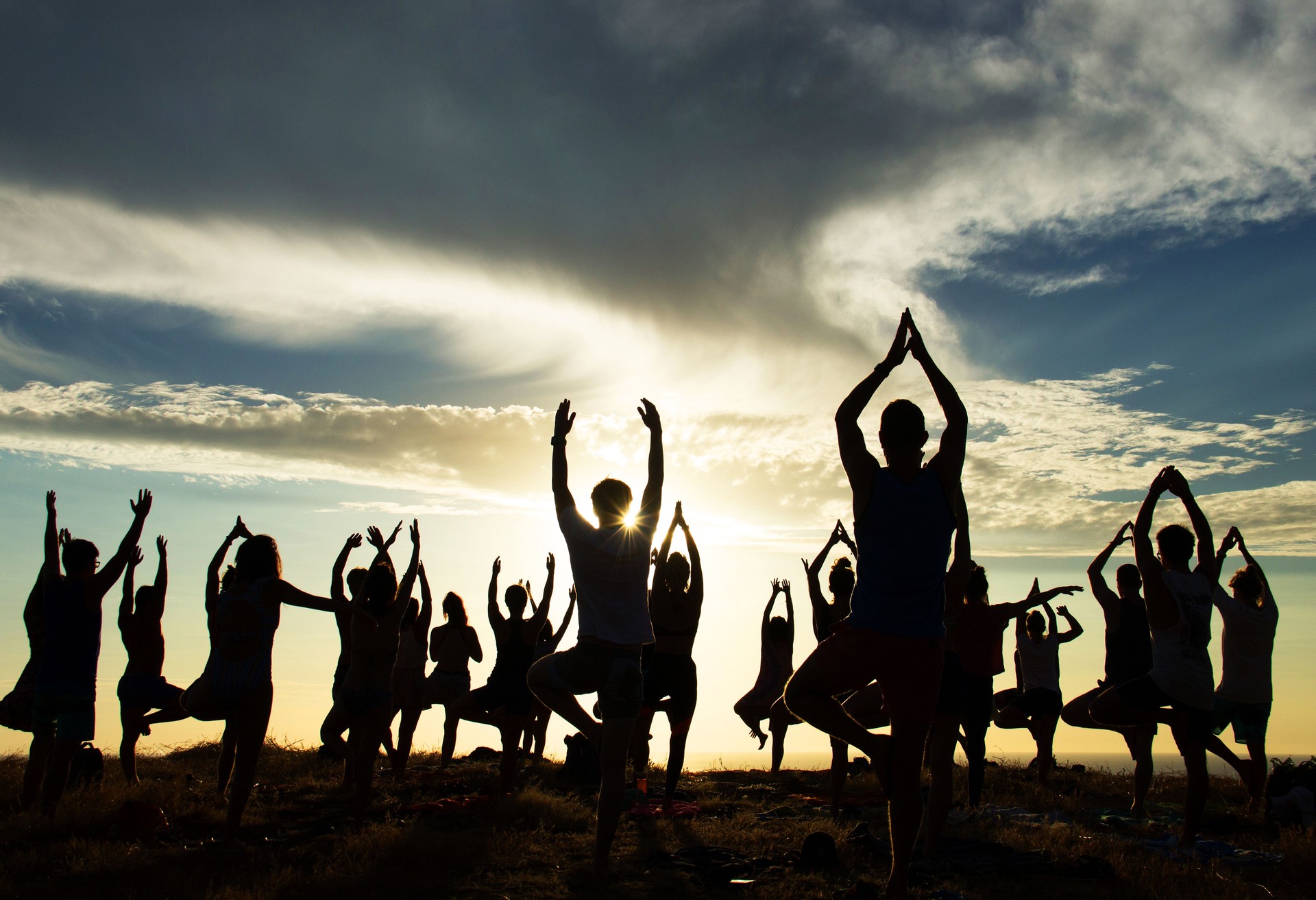 People Practicing Yoga at Sunset